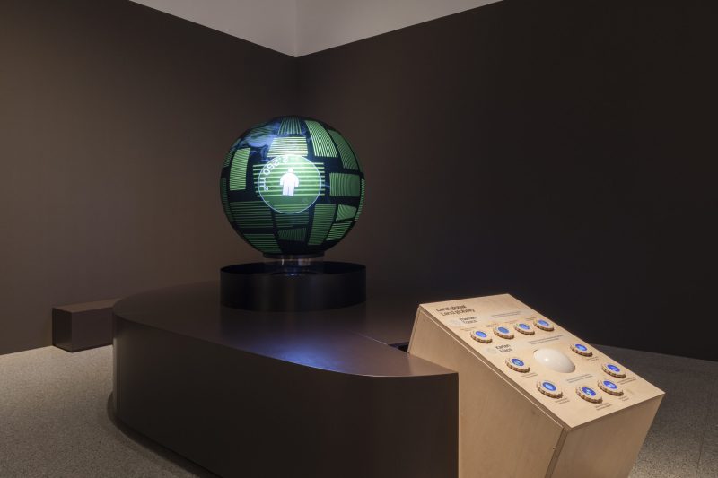 Interactive globe: spherical projection of land data with a control desk, trackball and topic buttons