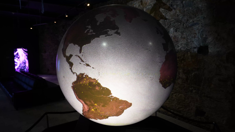 Globe showing North and South America, with yellow data points marking events across South America, video still